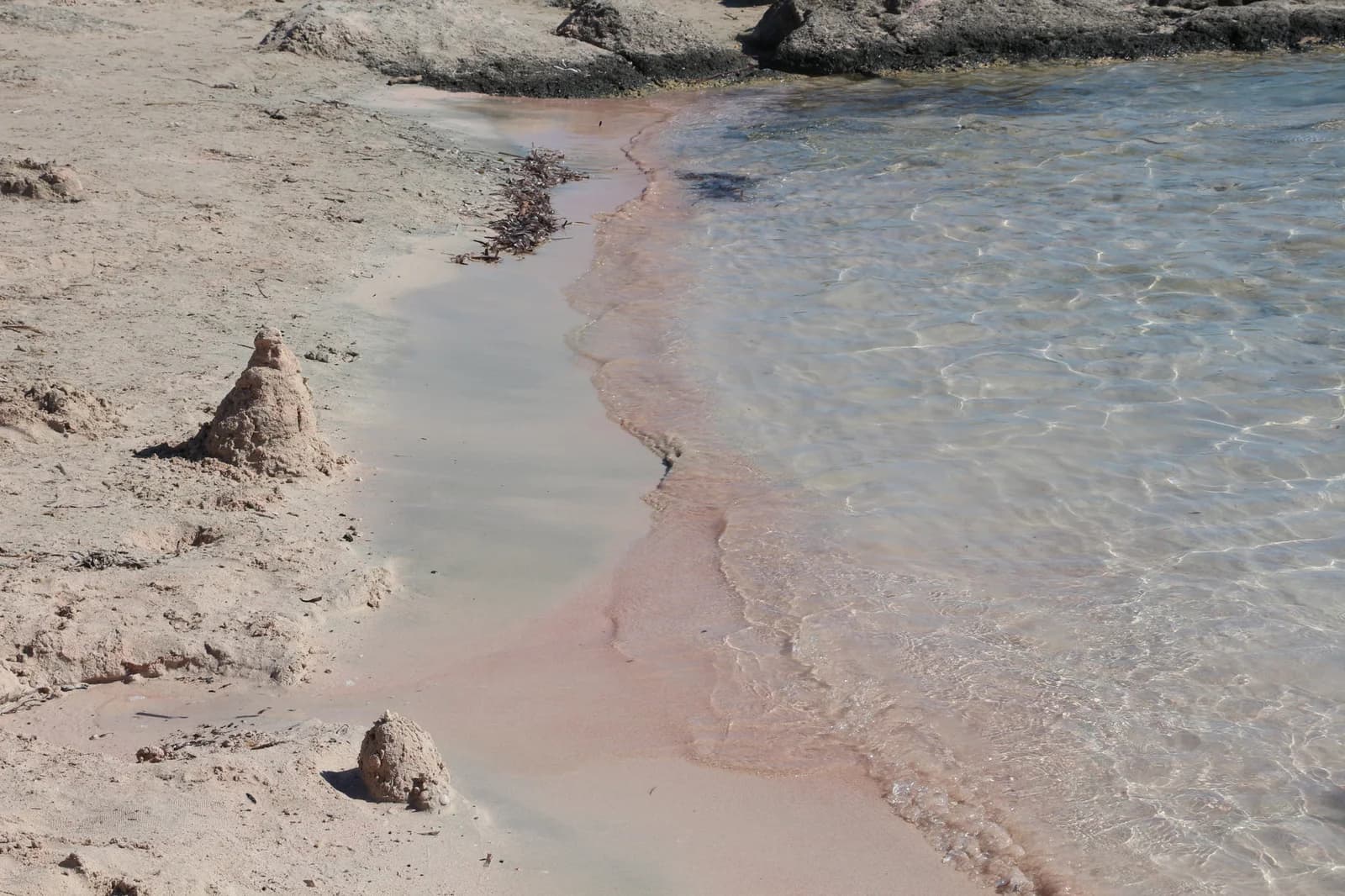 Pale pink sand beside the shoreline at Elafonisi